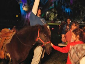 Children meeting a pony during the Spirit of Christmas family holiday event