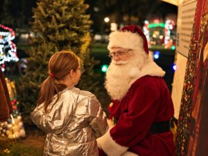 Child enjoying a festive visit with Santa at Spirit of Christmas in Destrehan
